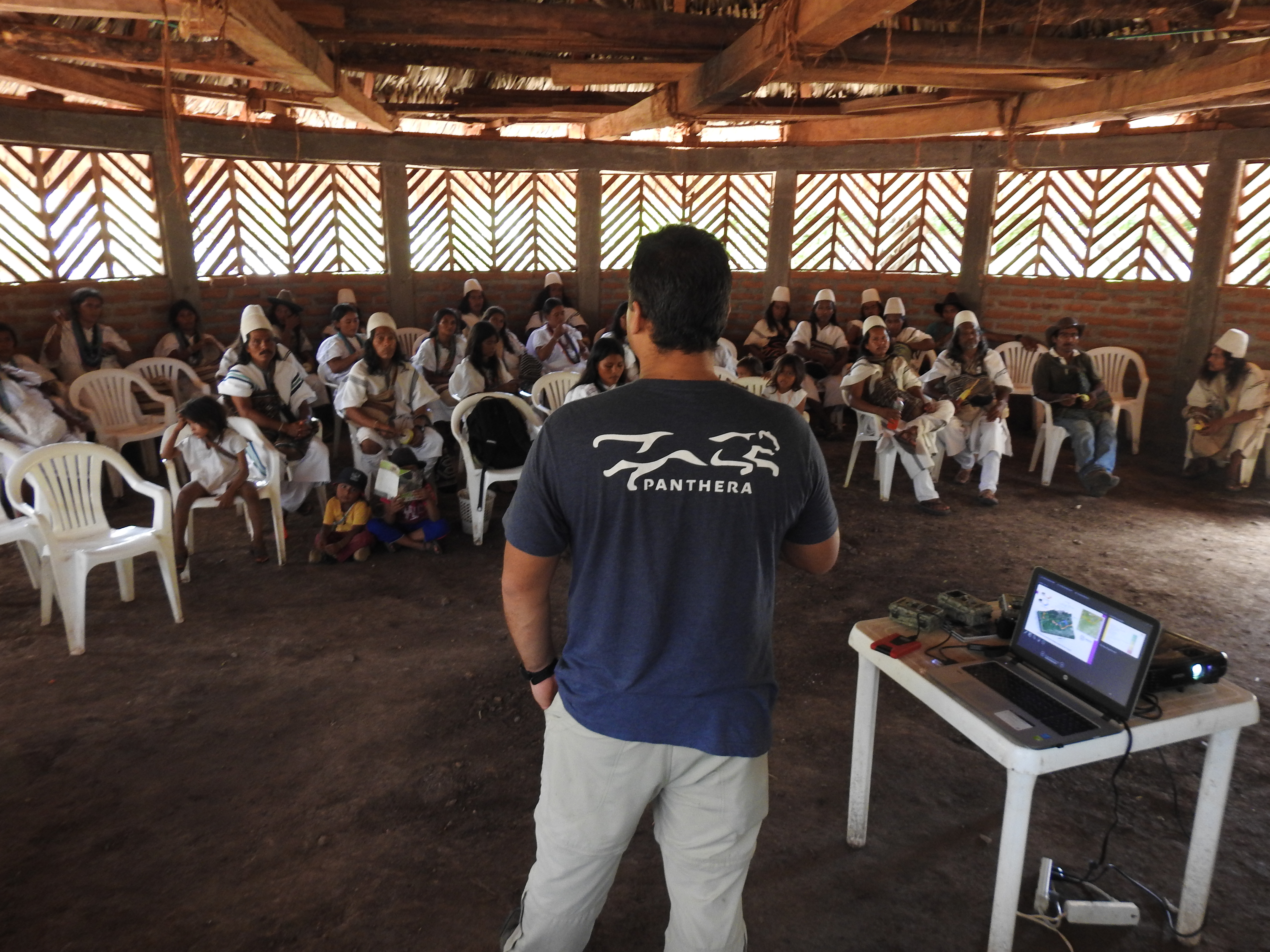 "Man giving presentation regarding Colombia Program to the natives"