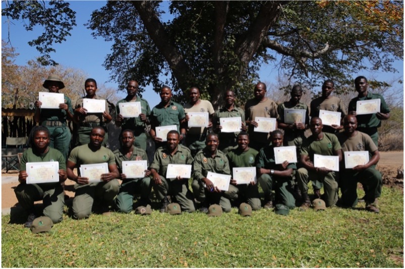 Group photo of people holding certificates