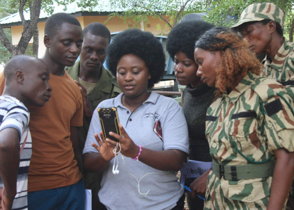 Panthera staff member shows colleagues how to use SMART technology