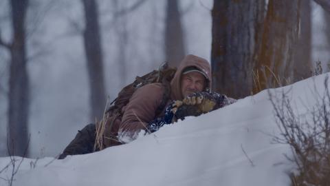 Mark Elbroch holding binoculars